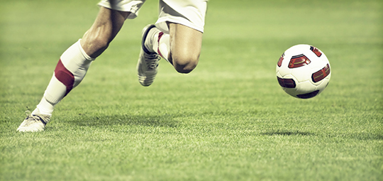 Football player running after ball